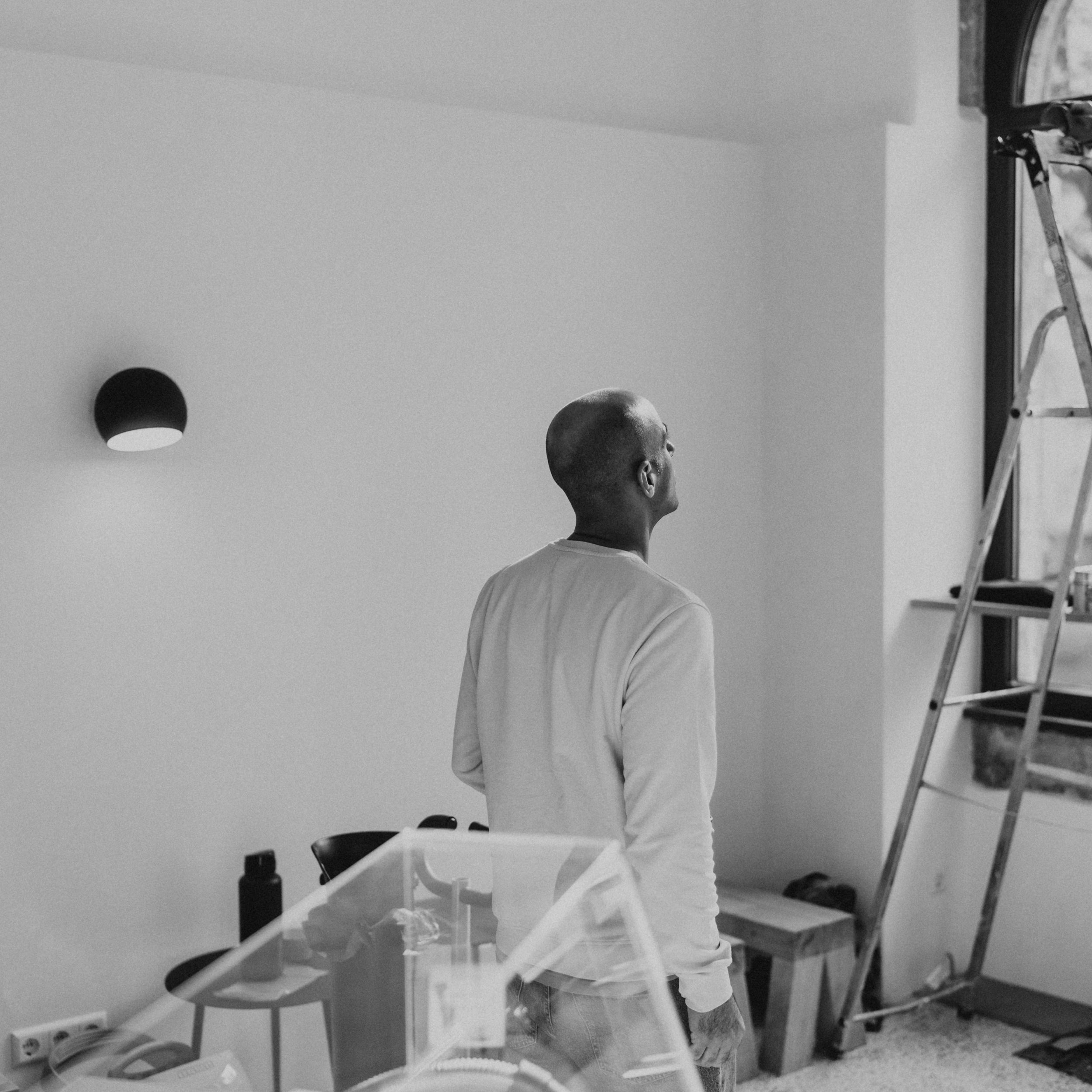 Armin Zandieh standing in the midst of the construction site within the iaro ost coffeeshop.