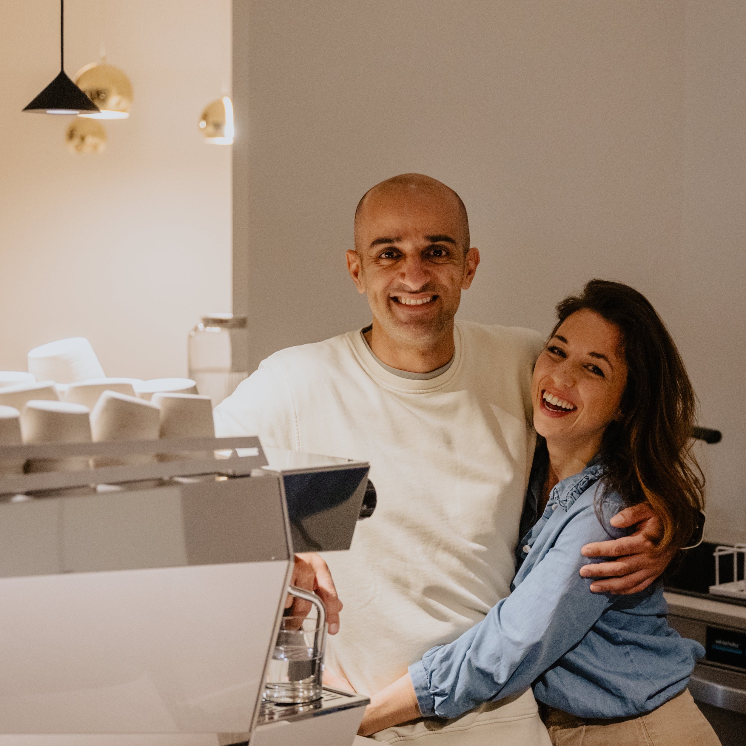 Armin and Nabila Zandieh are standing arm in arm inside their brand new Coffeeshop: iaro ost.