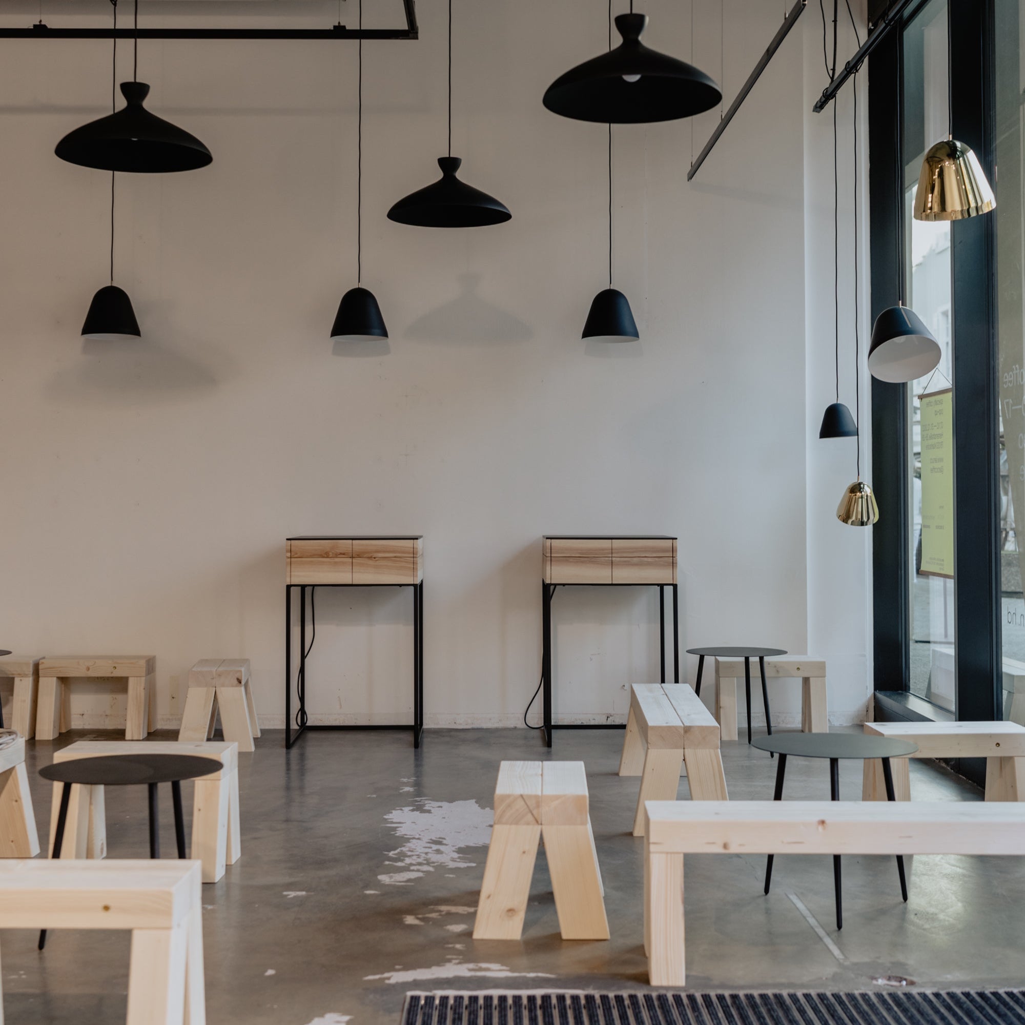 Different models of nyta pendants of the pretty and tilt variety hanging on the ceiling in the iaro pop up store.