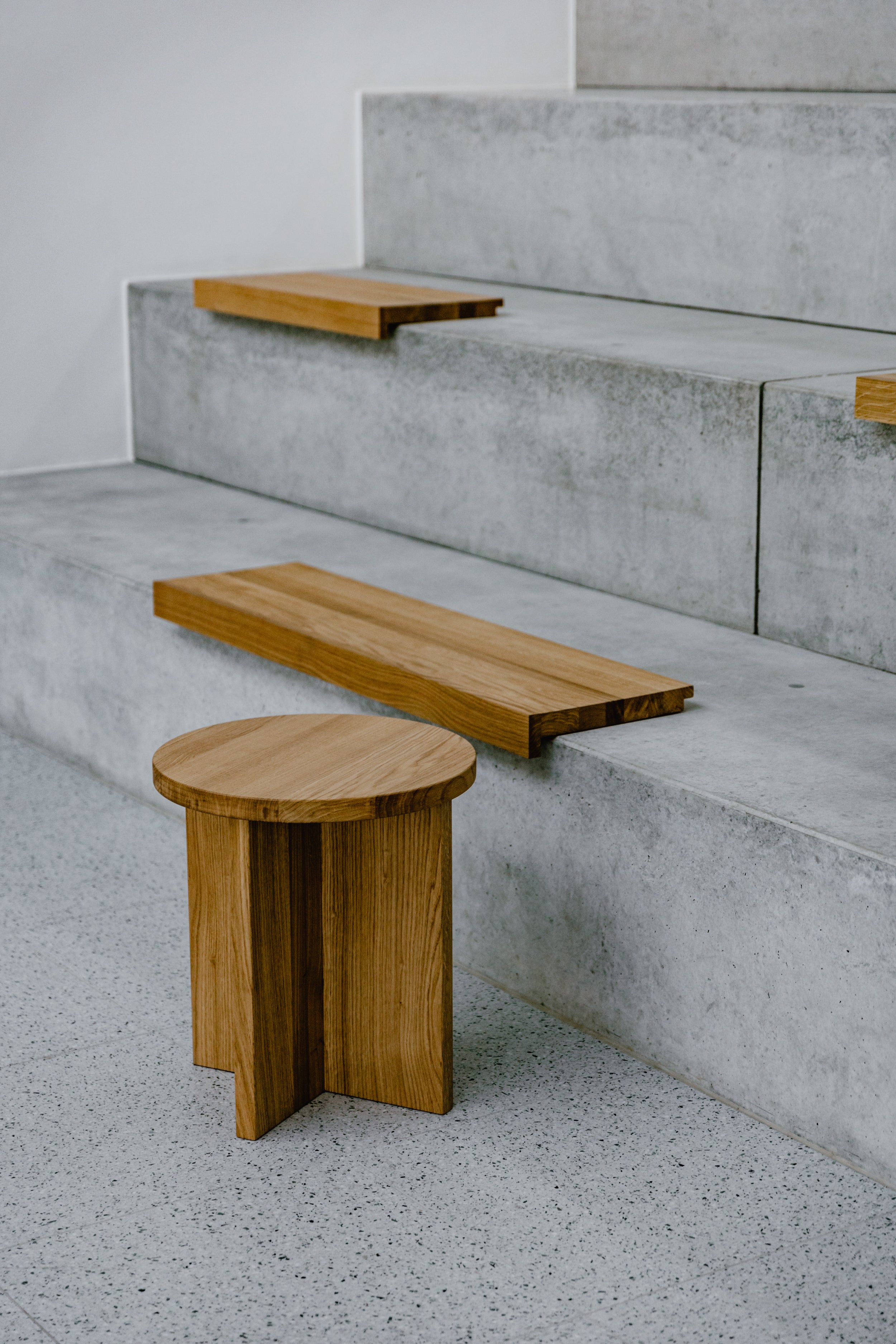 concrete atrium with wooden seats and coffee table