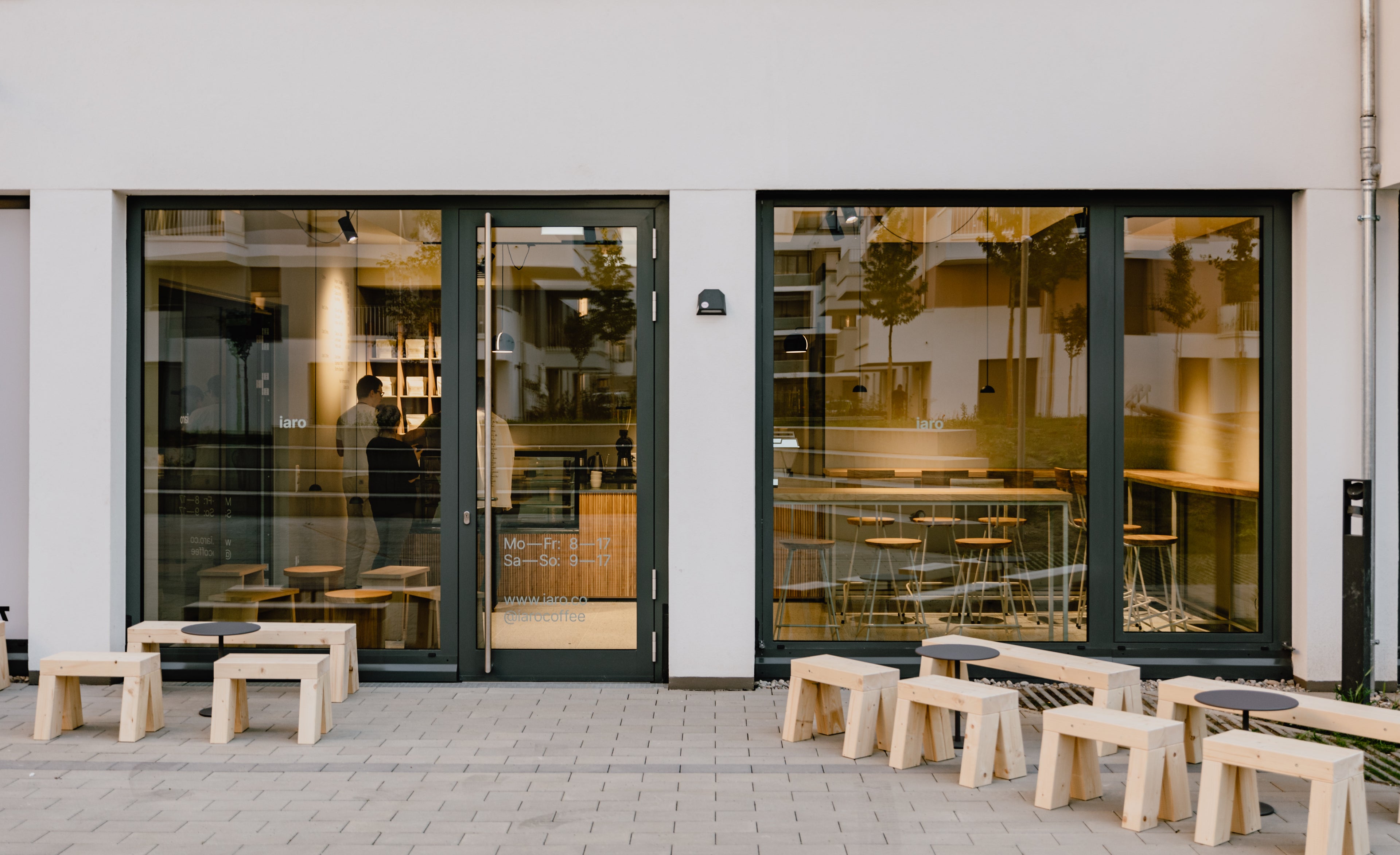 exterior view of the coffee shop with low tables and stools