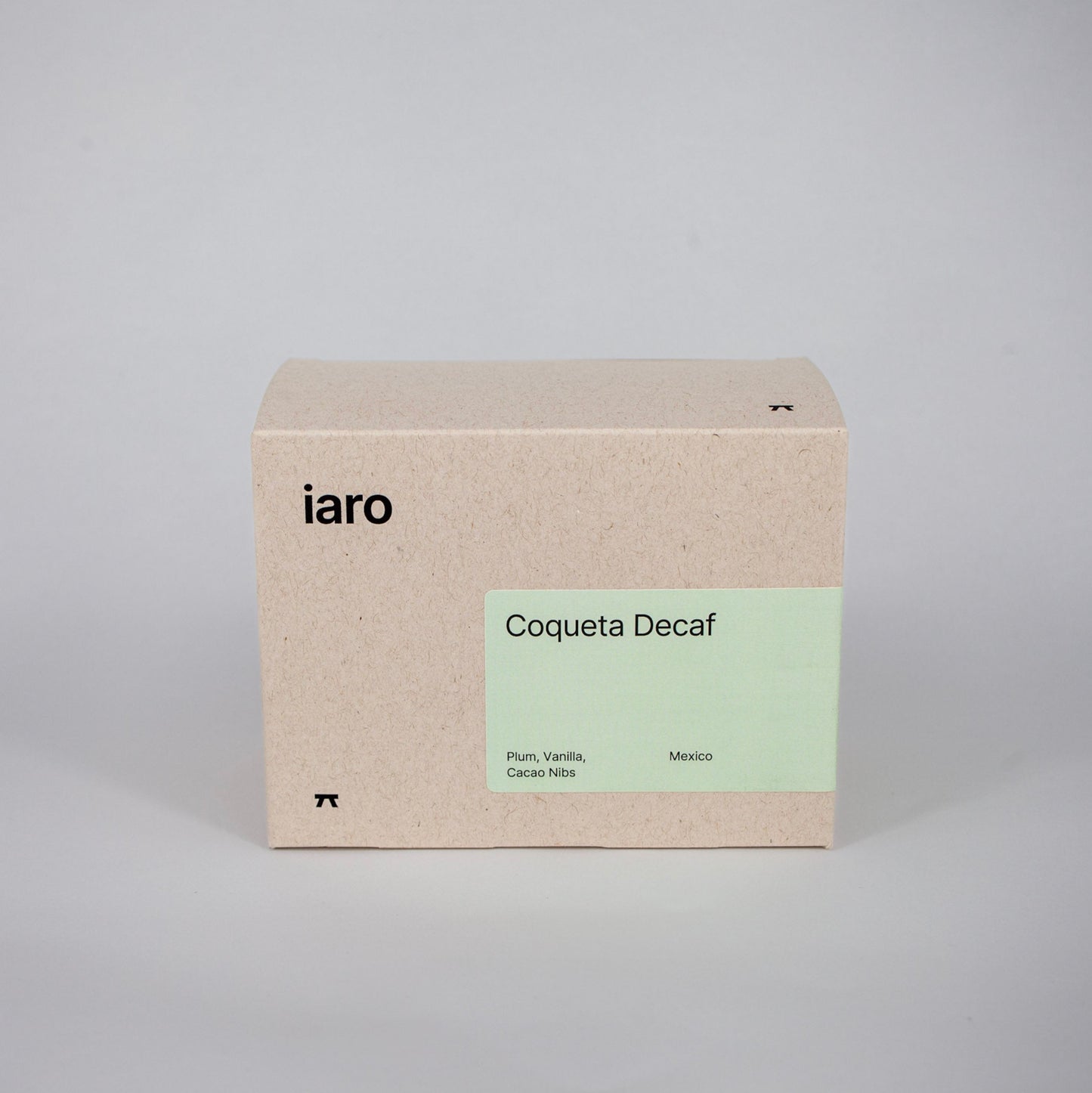 cardboard coffeepack with 250g of specialty beans with a pale green label and black logo