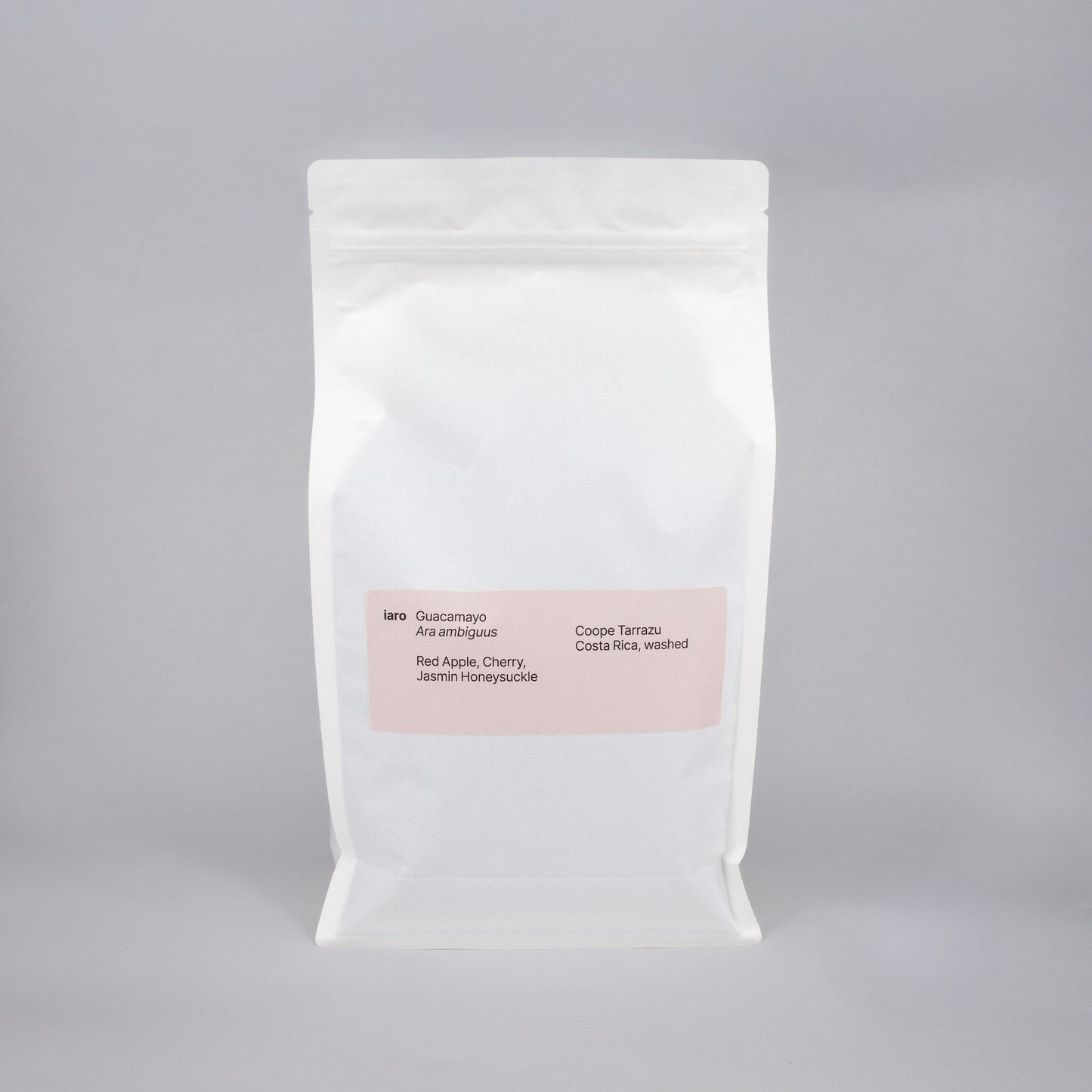 white bag of specialty coffee beans with a peach colored label