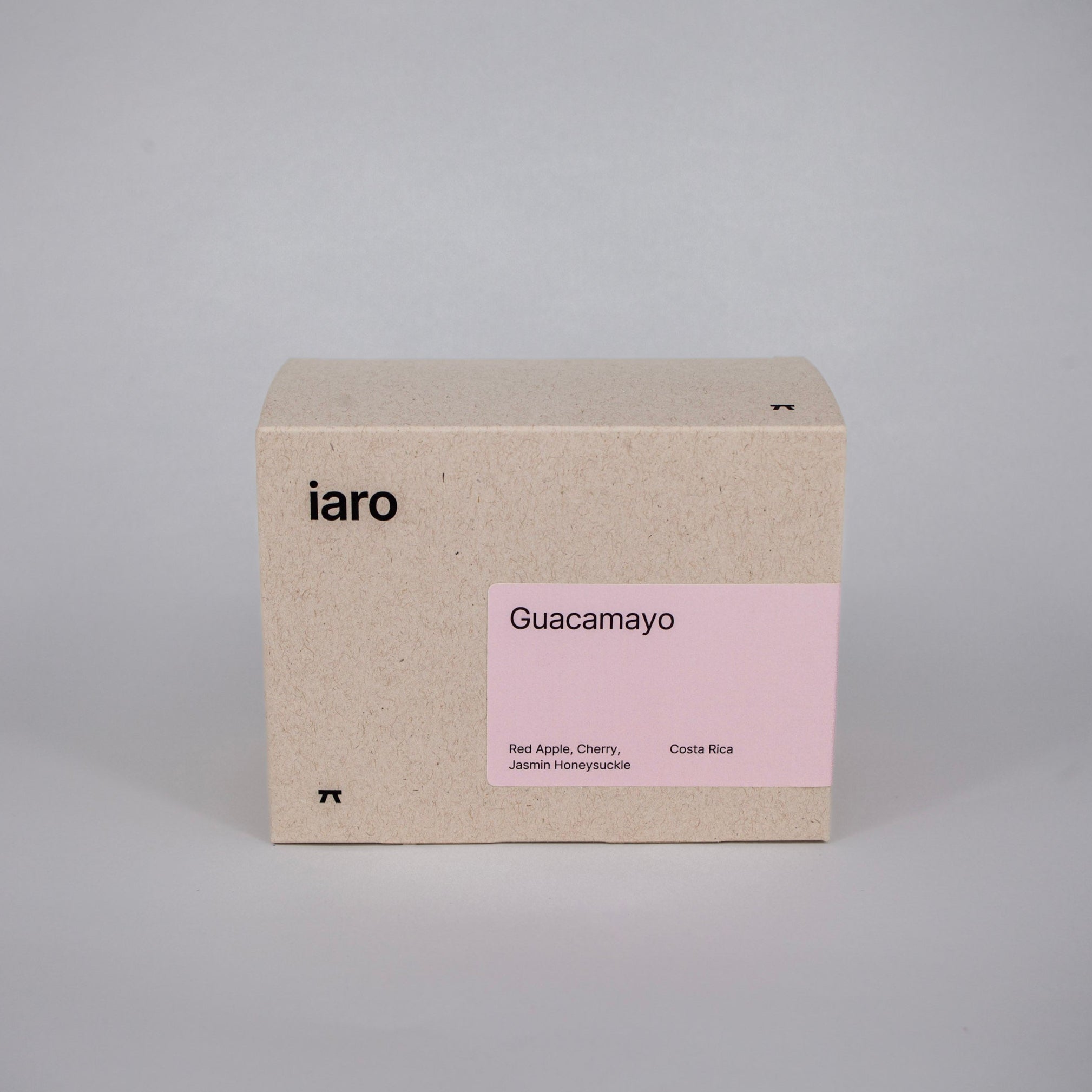 cardboard coffeepack with 250g of specialty beans with a pale pink label and black logo